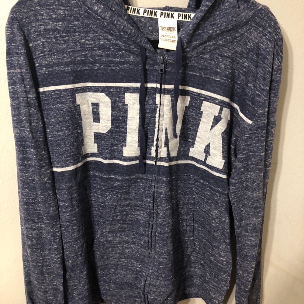 Pink full zip sweater.